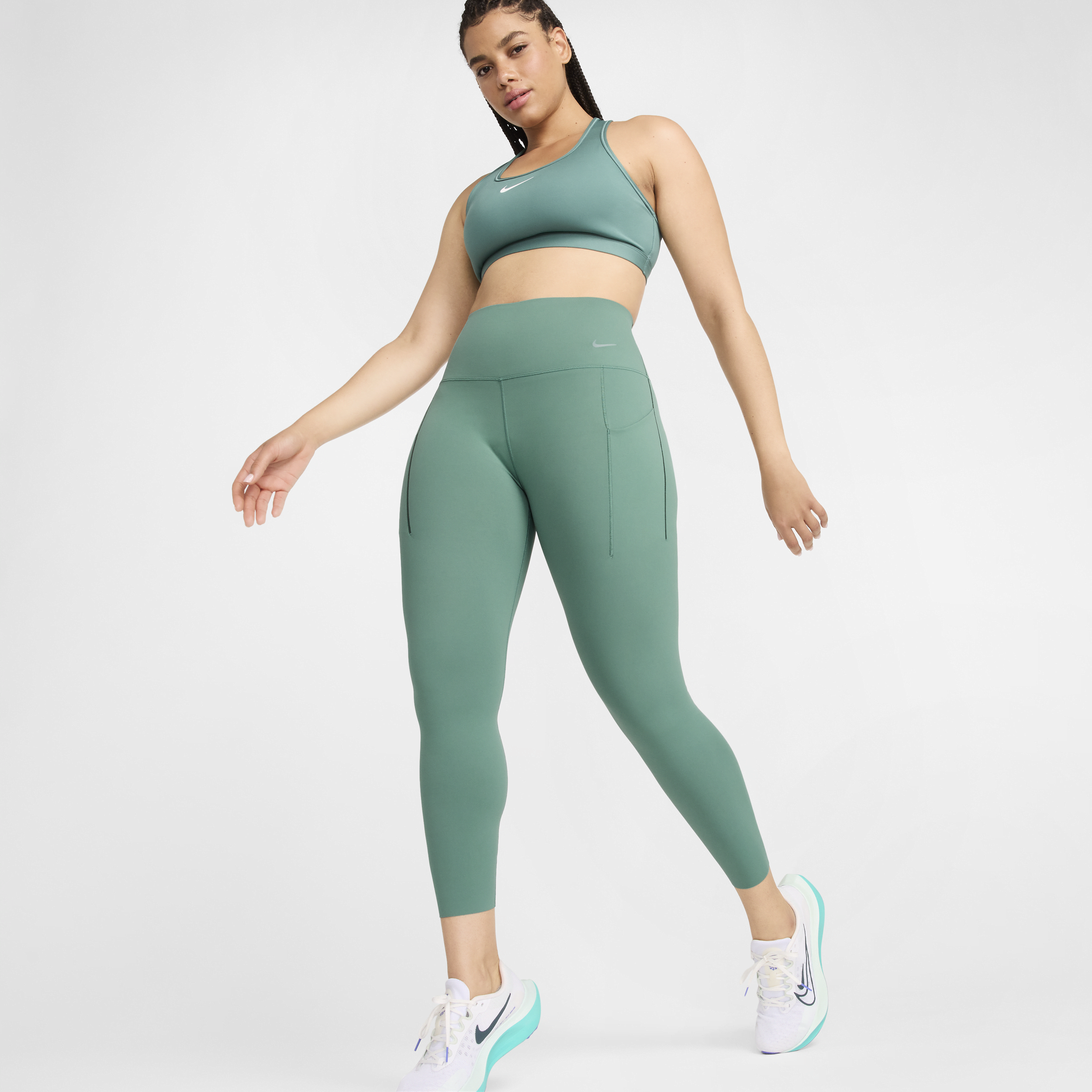 Shop Nike Women's Universa Medium-support High-waisted 7/8 Leggings With Pockets In Green