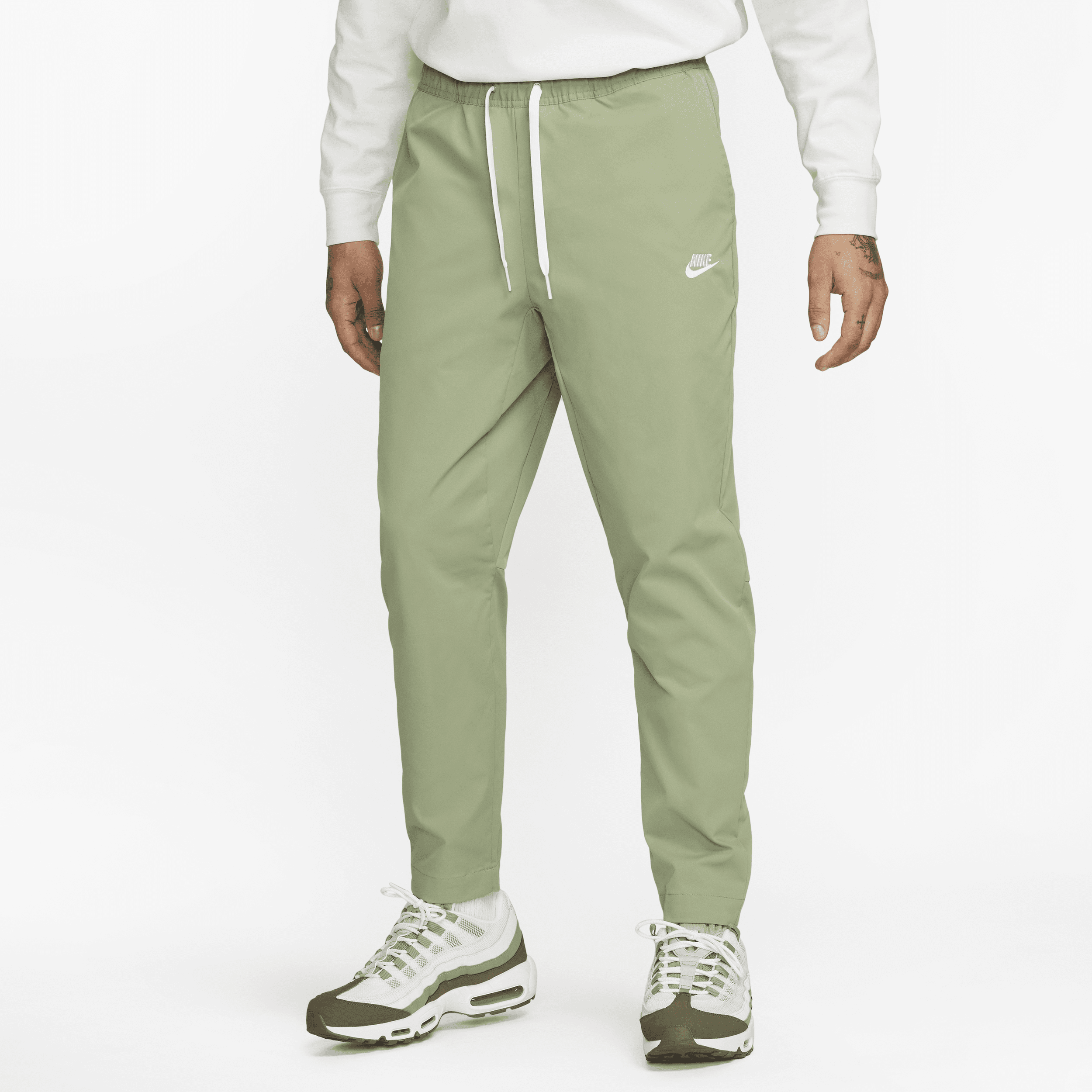 Shop Nike Men's Club Woven Tapered Leg Pants In Green