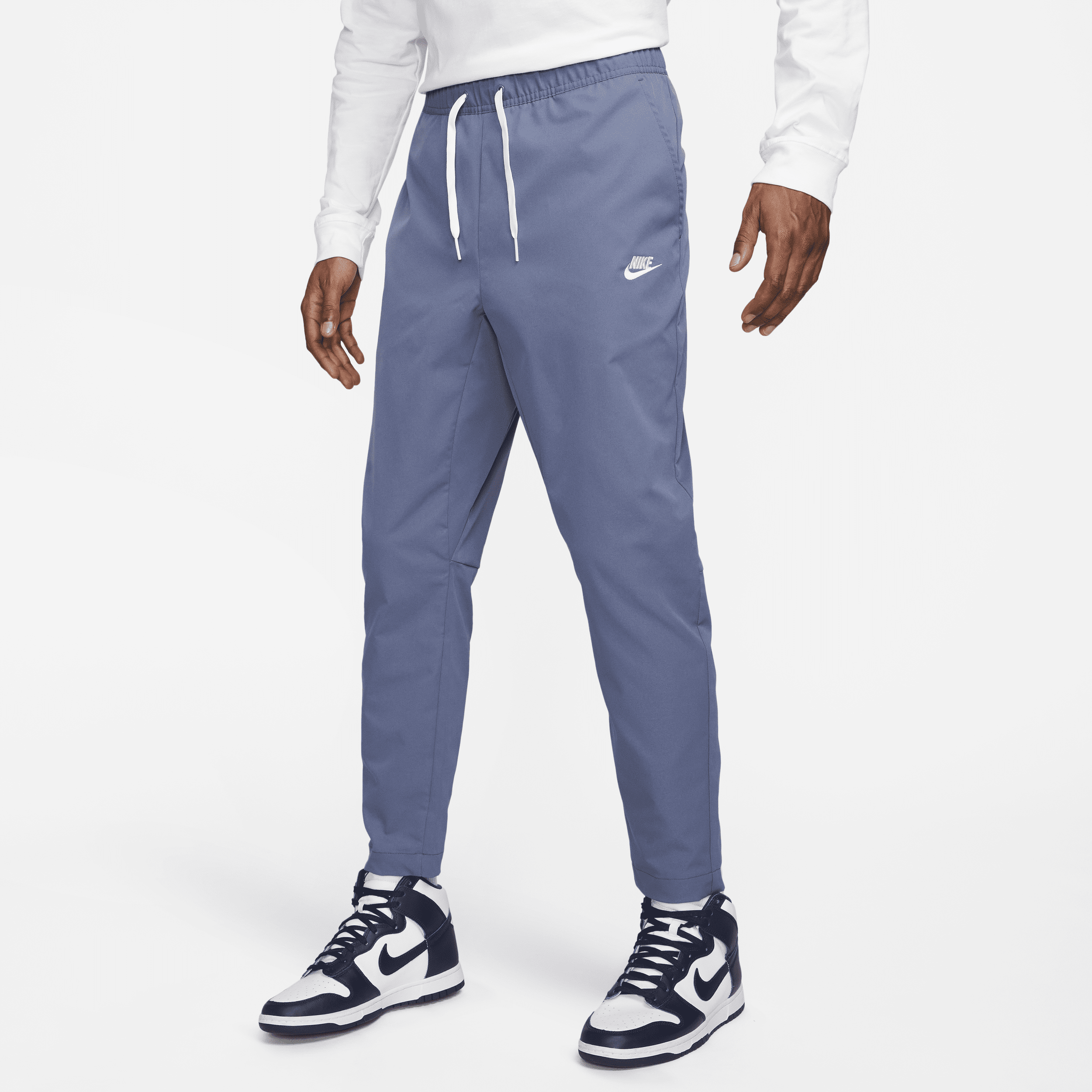 Shop Nike Men's Club Woven Tapered Leg Pants In Blue