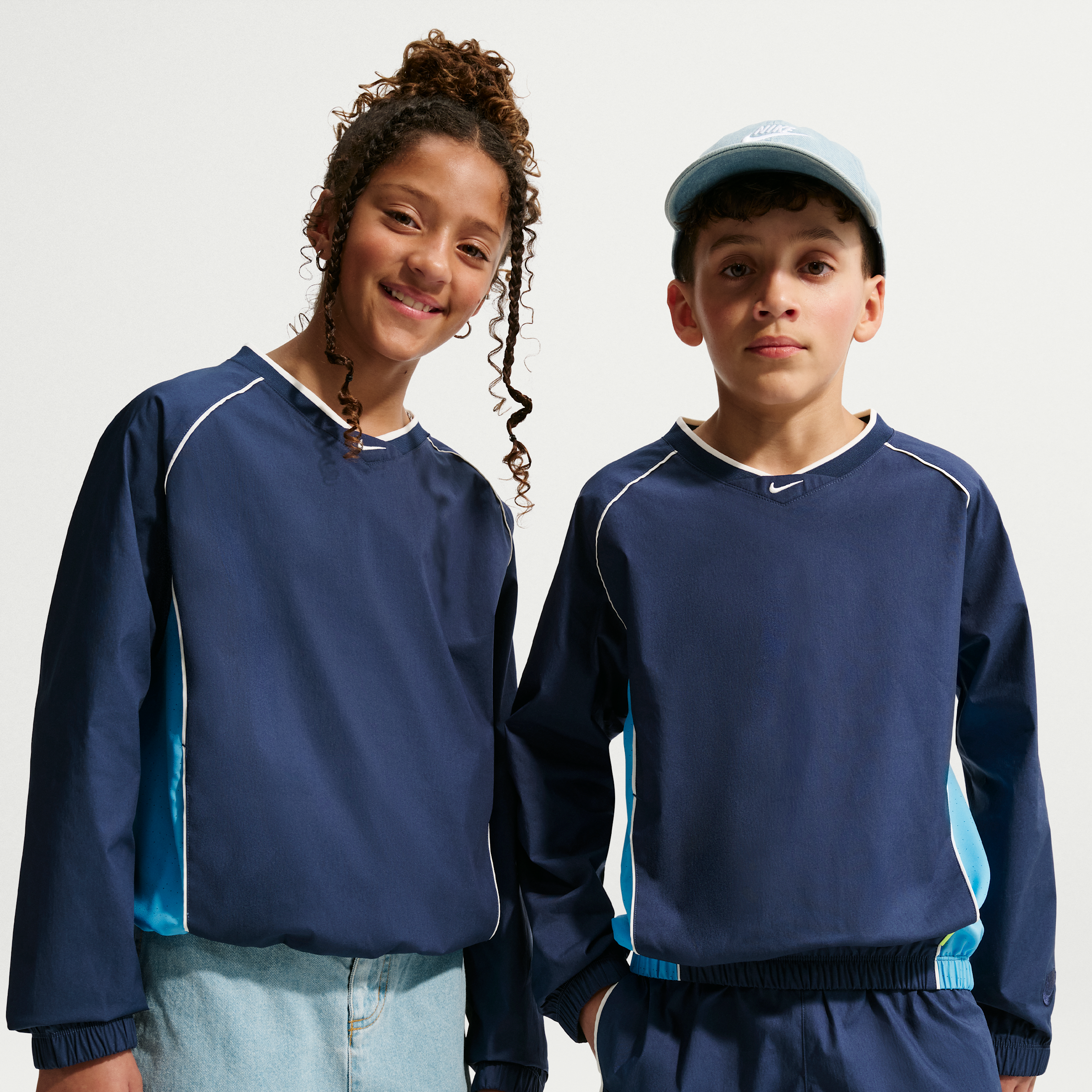 Nike Sportswear Big Kids' Woven V-Neck Long-Sleeve Top in Blue | IF2305-410