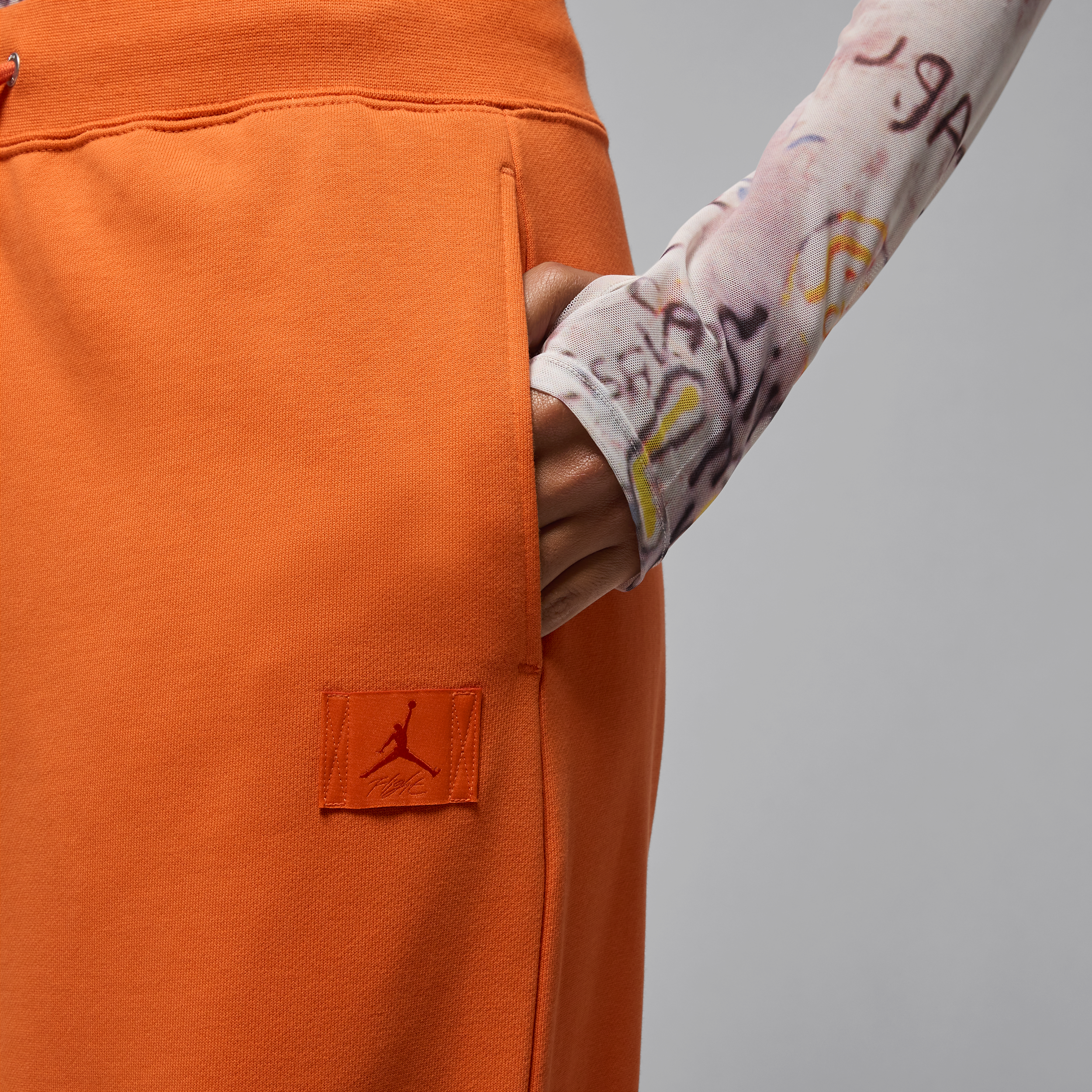 Jordan Flight Fleece damesbroek van sweatstof met open zoom Oranje