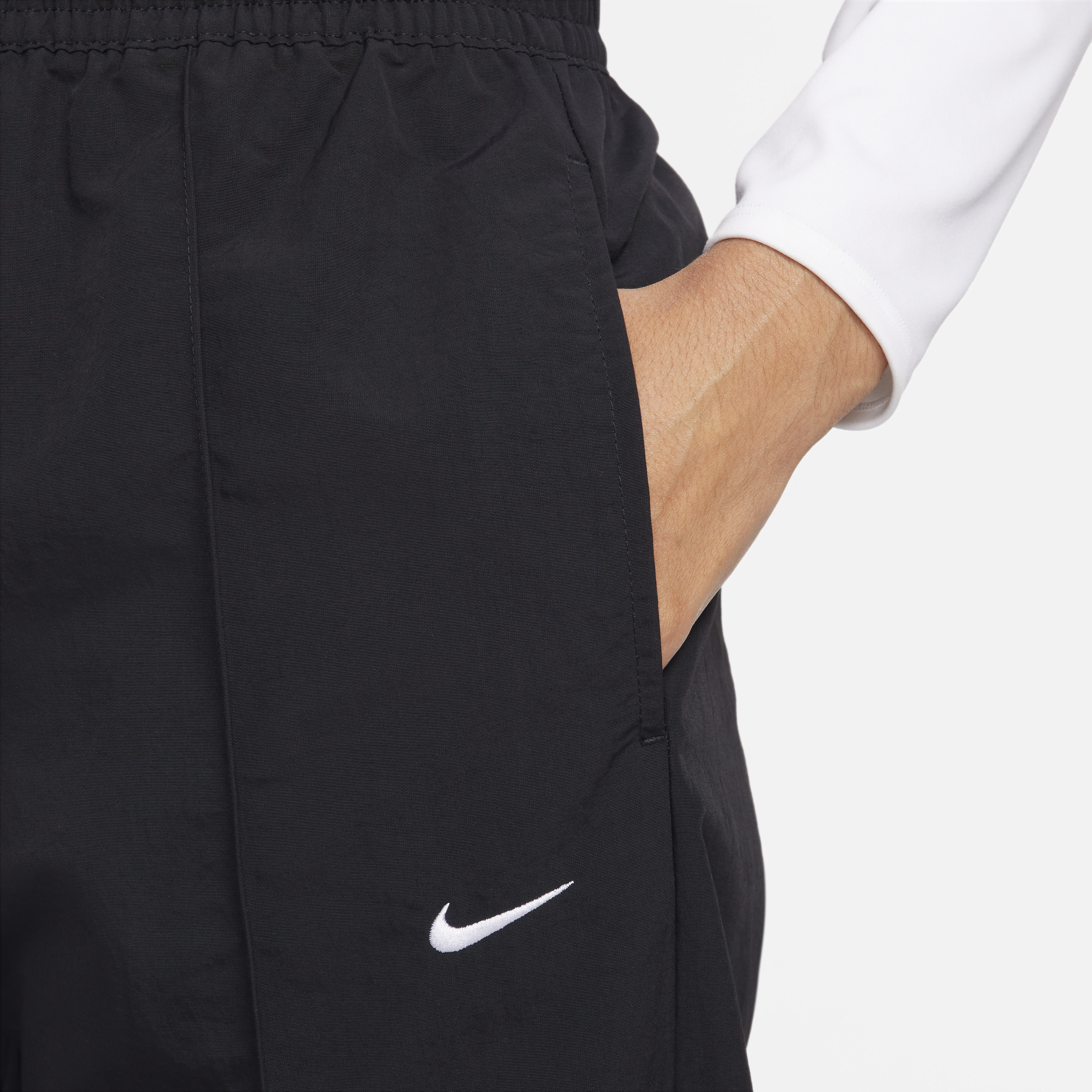 Pantalon taille mi-haute à ourlet ouvert Nike Sportswear Everything Wovens pour femme - Noir