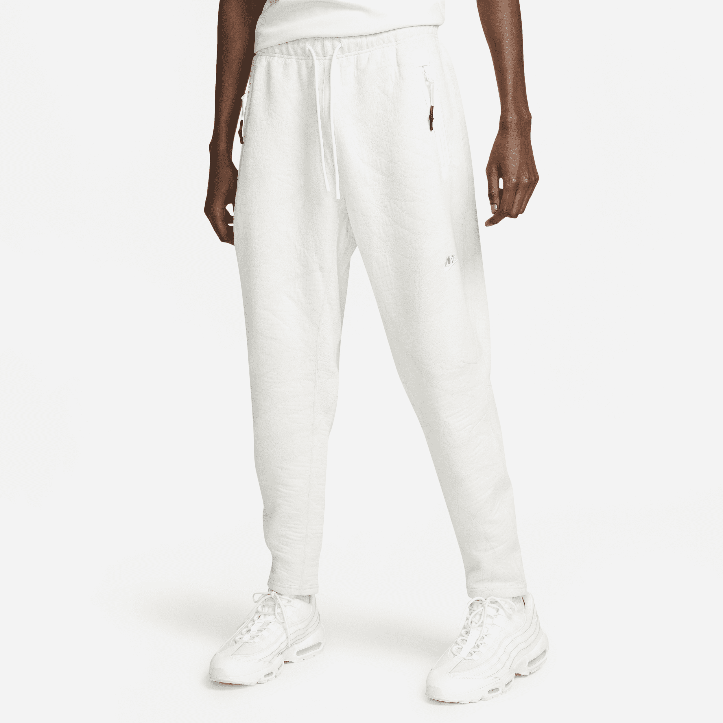 Zaawansowane technologicznie męskie spodnie z nadrukiem w kwiaty Nike Sportswear Therma-FIT ADV Tech Fleece - Biel