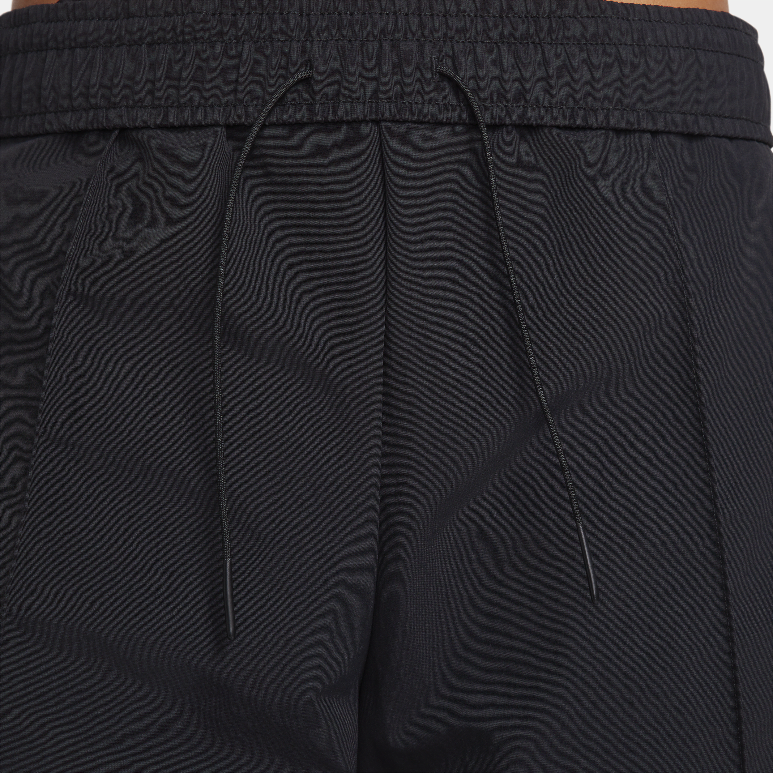 Pantalon taille mi-haute à ourlet ouvert Nike Sportswear Everything Wovens pour femme - Noir