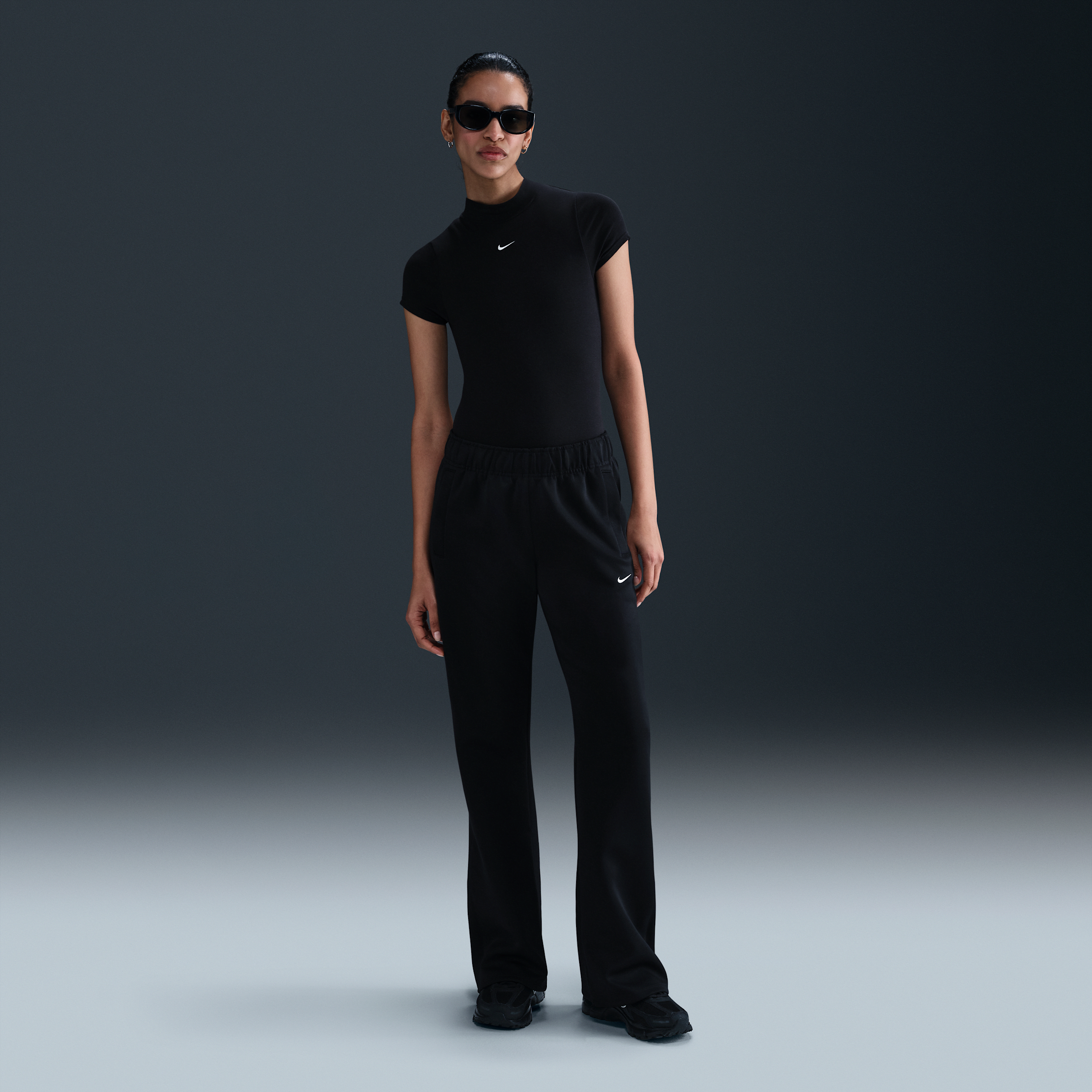 Pantaloni slim fit a vita media in maglia Nike Windrunner – Donna - Nero