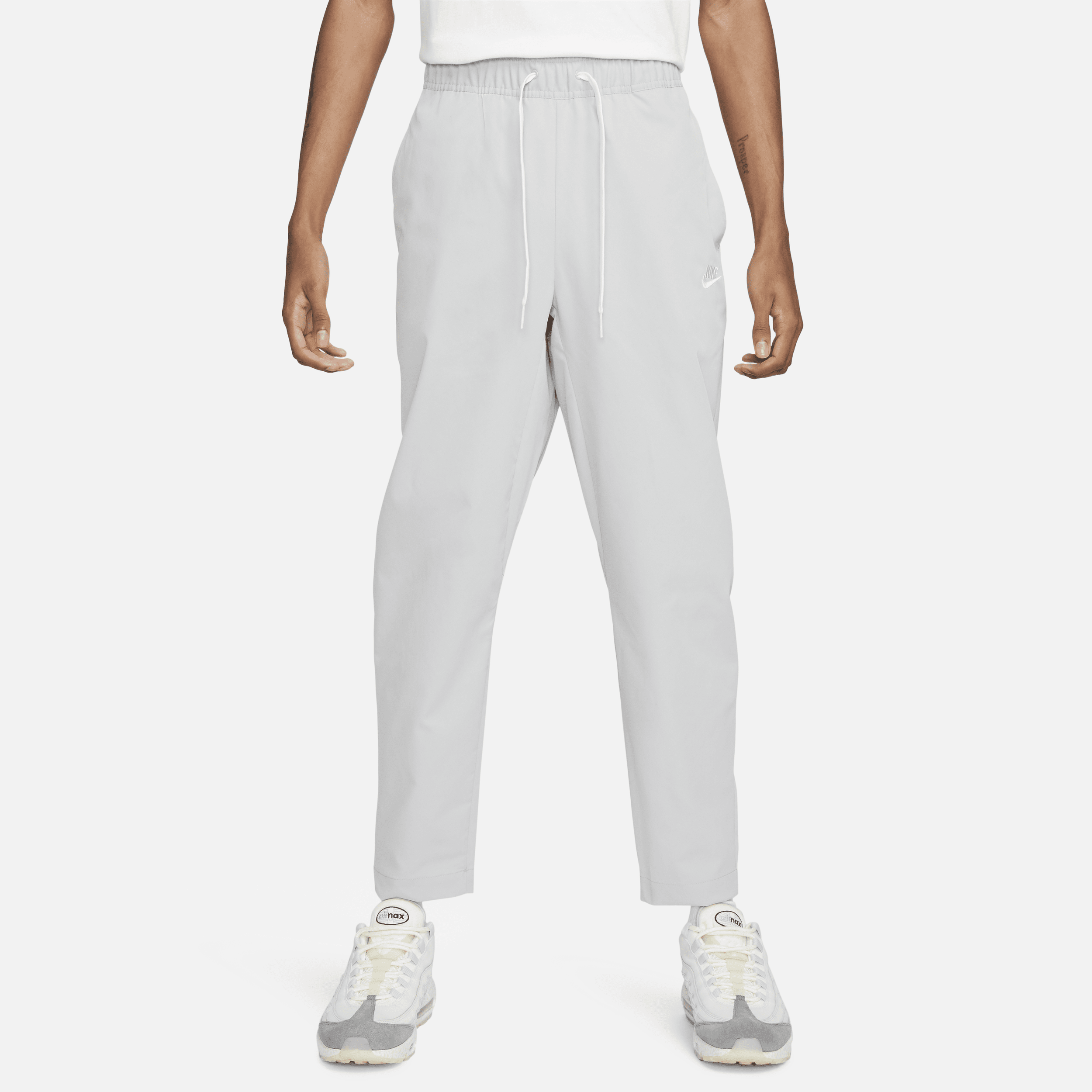 Pantaloni affusolati in tessuto Nike Club – Uomo - Grigio