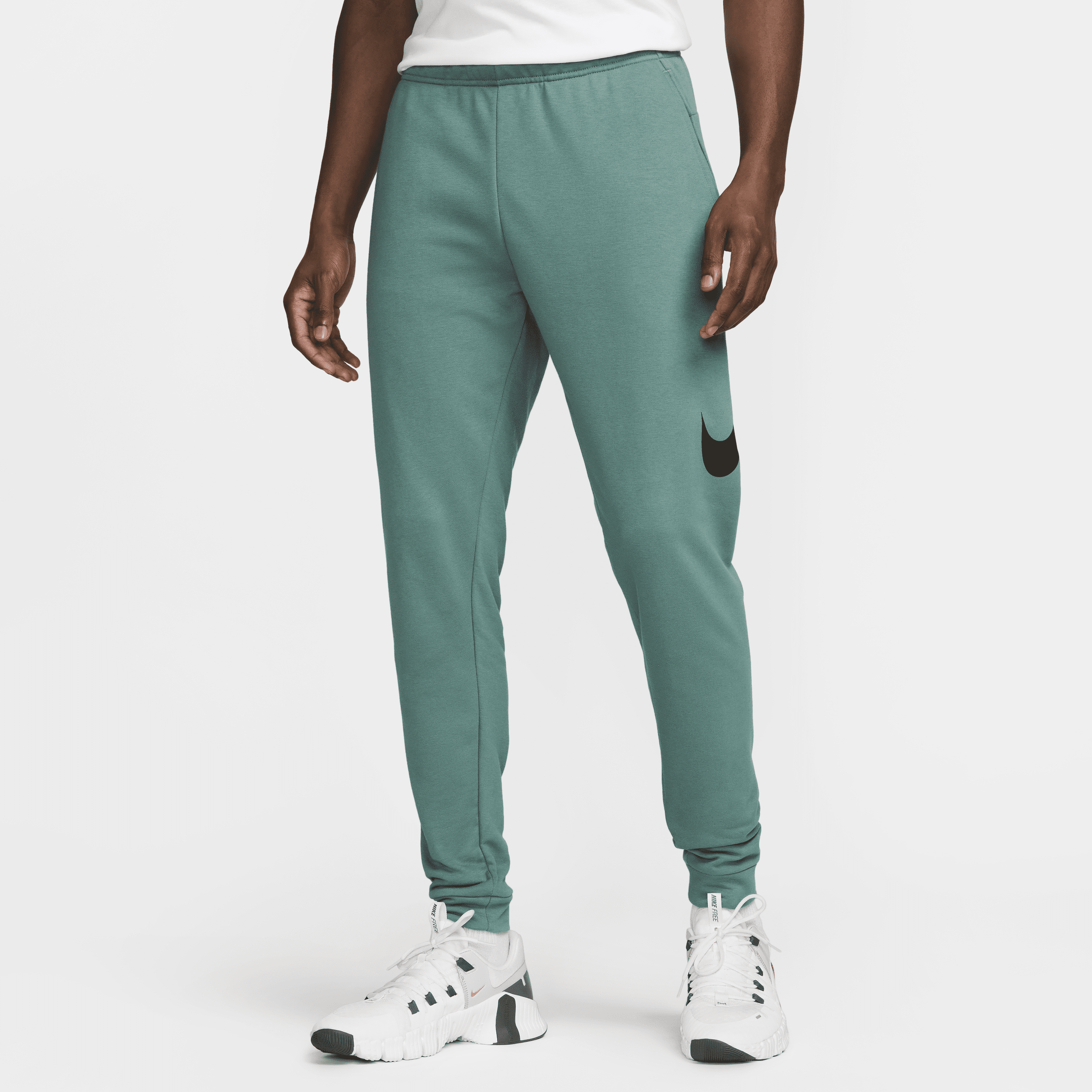 Pantaloni fitness Dri-FIT affusolati Nike Dry Graphic – Uomo - Verde