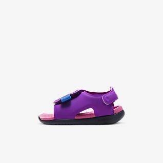 purple nike flip flops with gold check