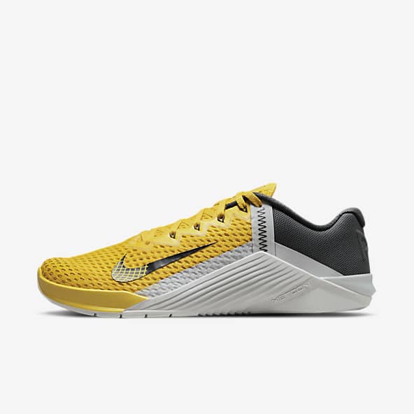 navy blue and yellow nike shoes
