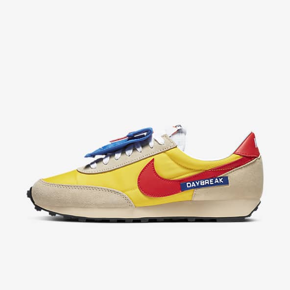 white and yellow nike shoes