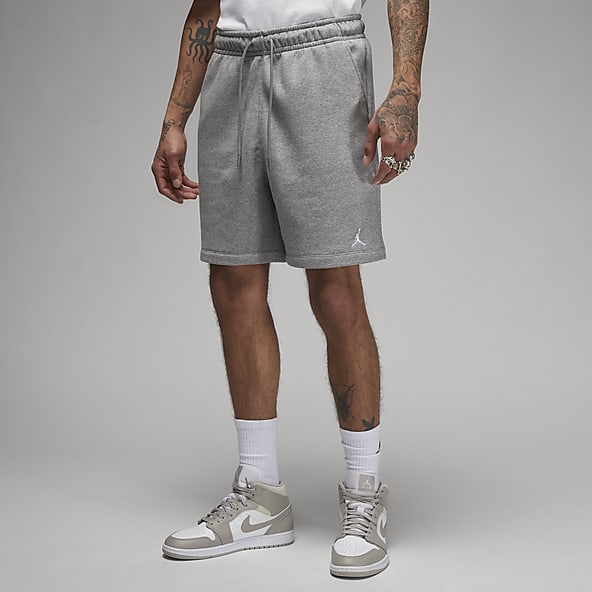 Nike® men's sweatshorts with purple & gold W on the left leg. Black.