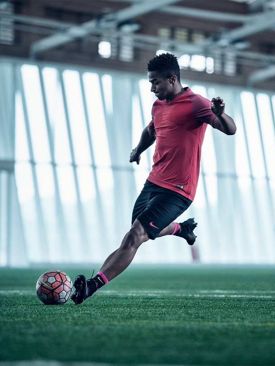 soccer ball and feet on the football field, football player in