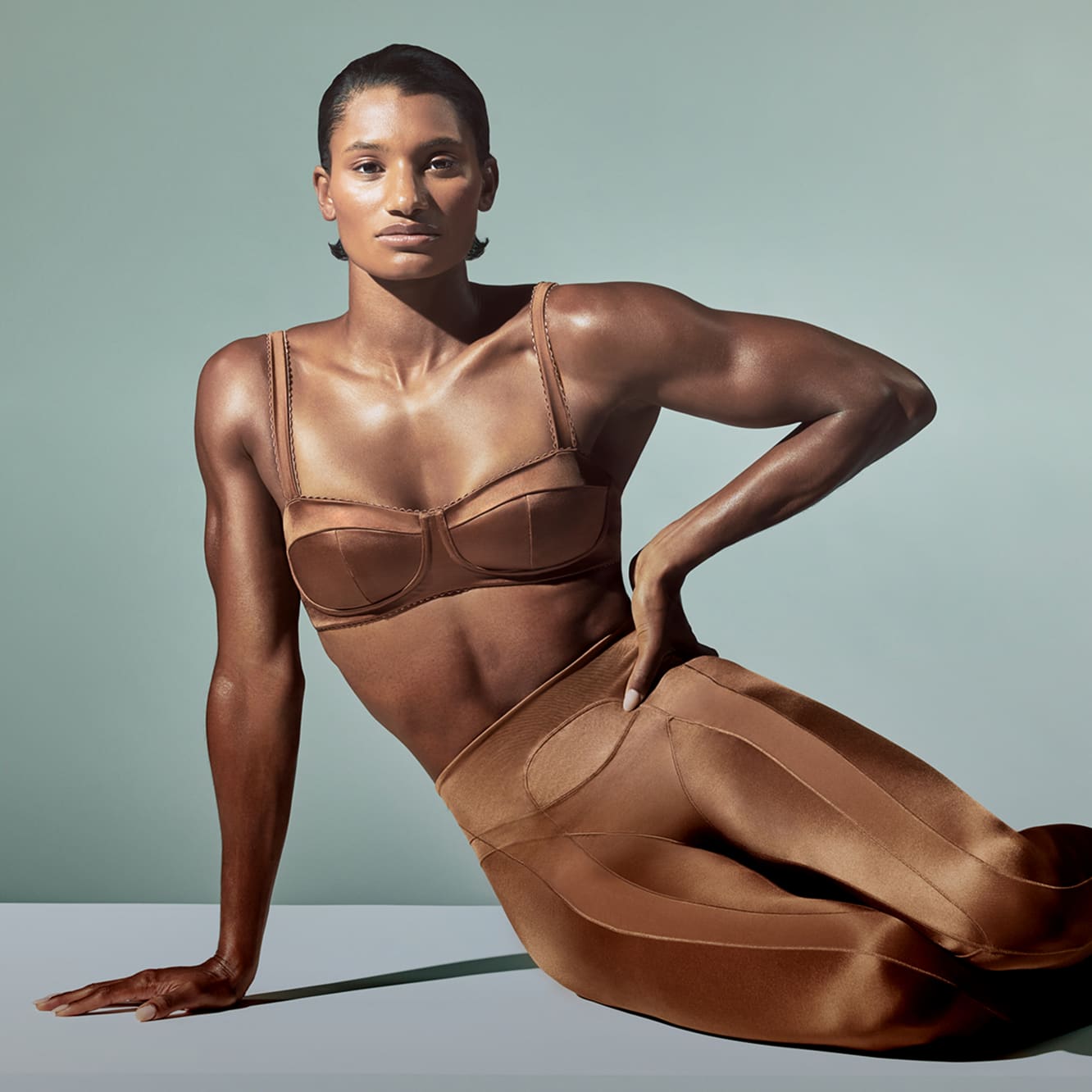 Anna Cockrell poses while sat on floor with a hand on her hip, wearing NikeSKIMS., Body Obsessed