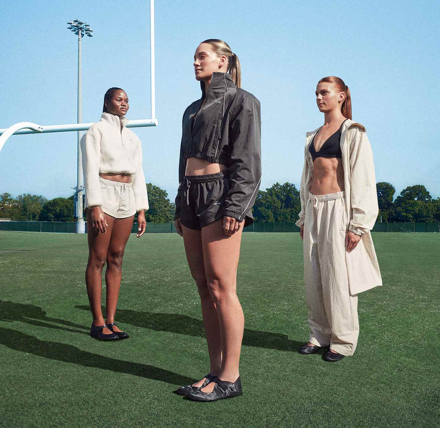Three athletes stood at individual angles, on an American Football pitch, wearing NikeSKIMS., New NikeSKIMS Outerwear