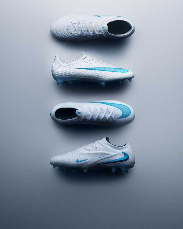 Trending Now, Four Nike Bright Lights Pack boots lying on a grey gradient surface, in white and blue., slide 2 of 4