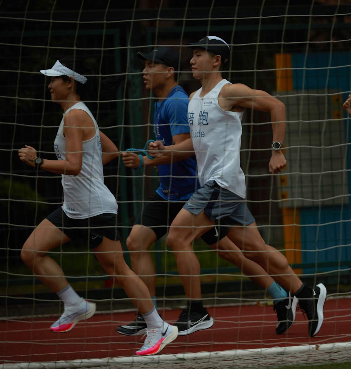Behind some visually impaired runners are running pacers