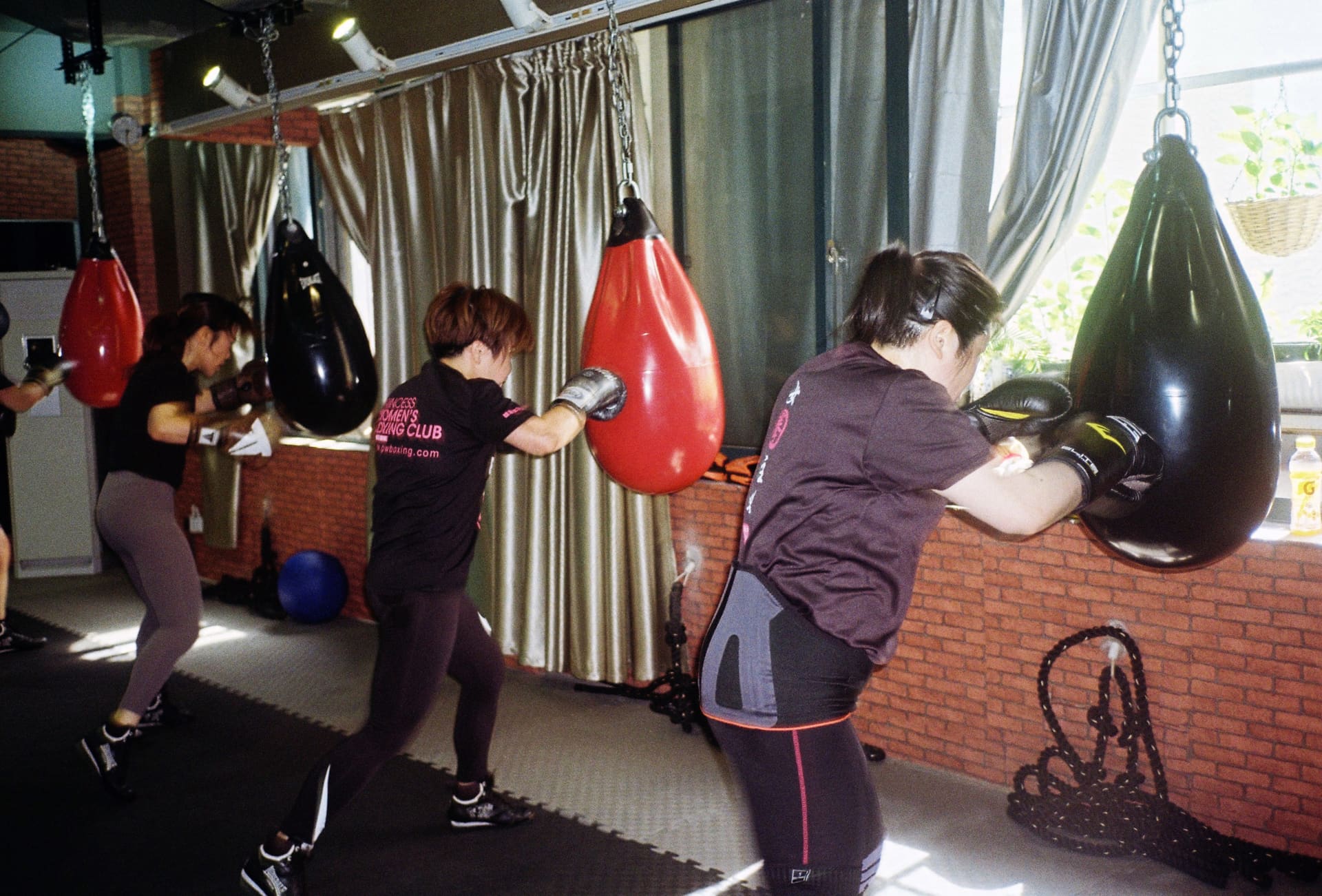Students practise sandbag hits at Princess Women's Boxing Club.