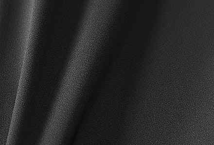 Close-up van een donkergrijze matte stof met een lichte rimpel in het materiaal., slide 3 of 9