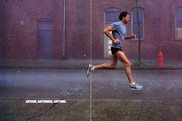 Action shot of an athlete wearing Nike Pegasus running shoes on a city street., slide 7 of 10