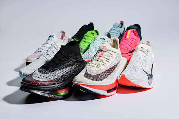 A collection of different high-performance Nike Running shoes on a white surface., slide 2 of 10