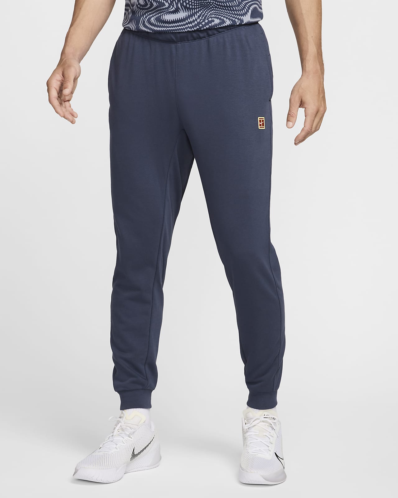 Męskie spodnie do tenisa z dzianiny dresowej NikeCourt Heritage