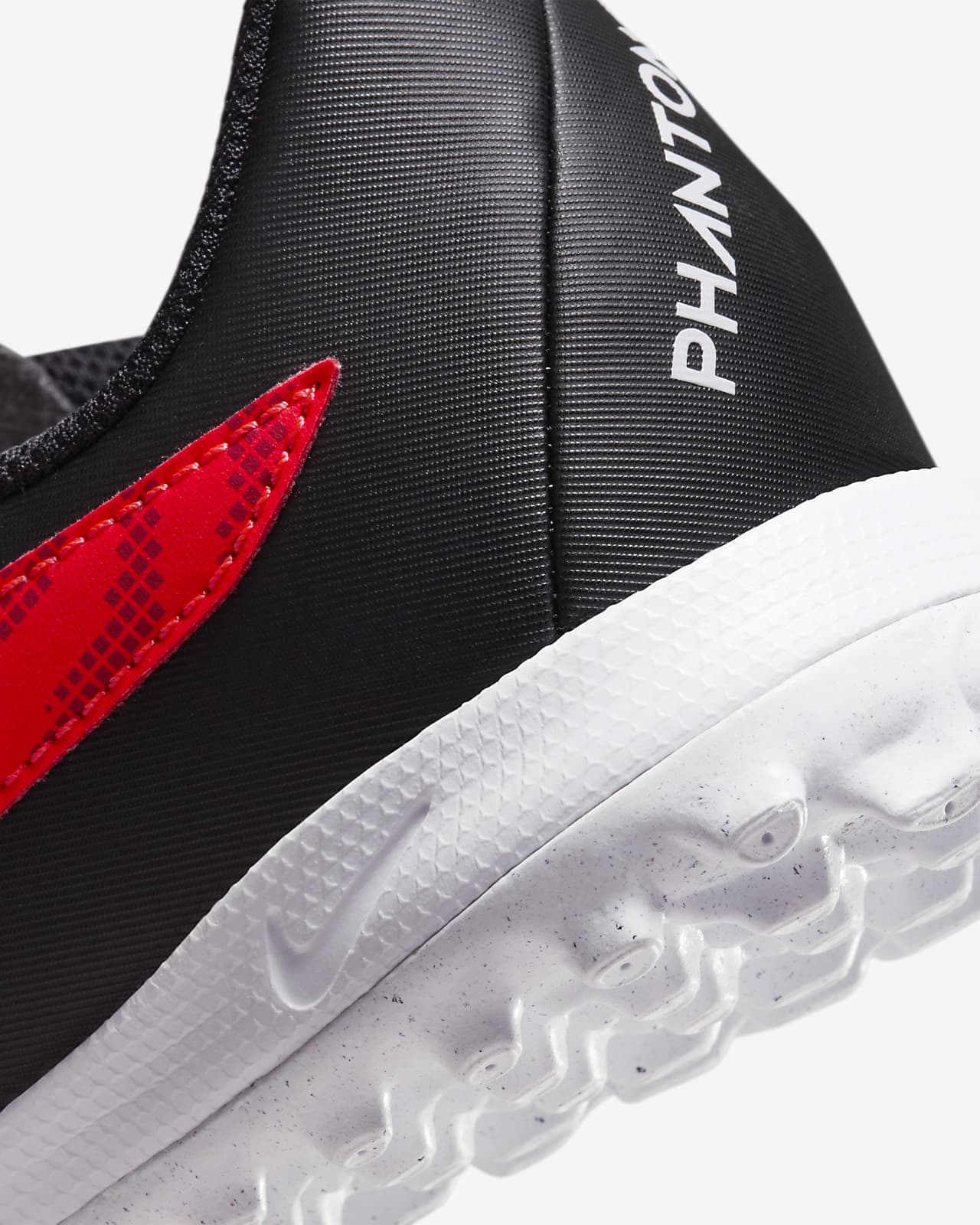 Nike Jr. Phantom GX Academy Big Kids' Turf Low-Top Soccer Shoes.