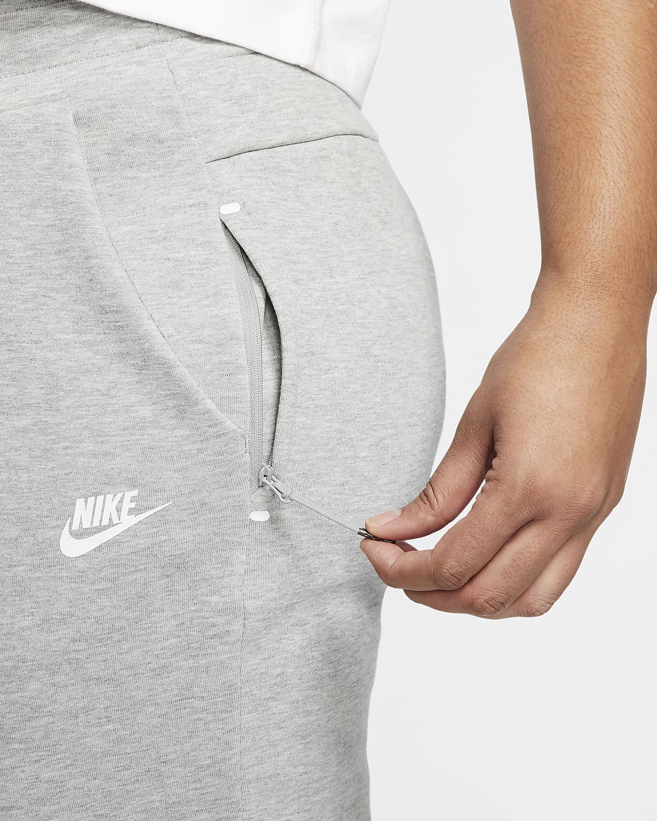 grey and white nike tech pants
