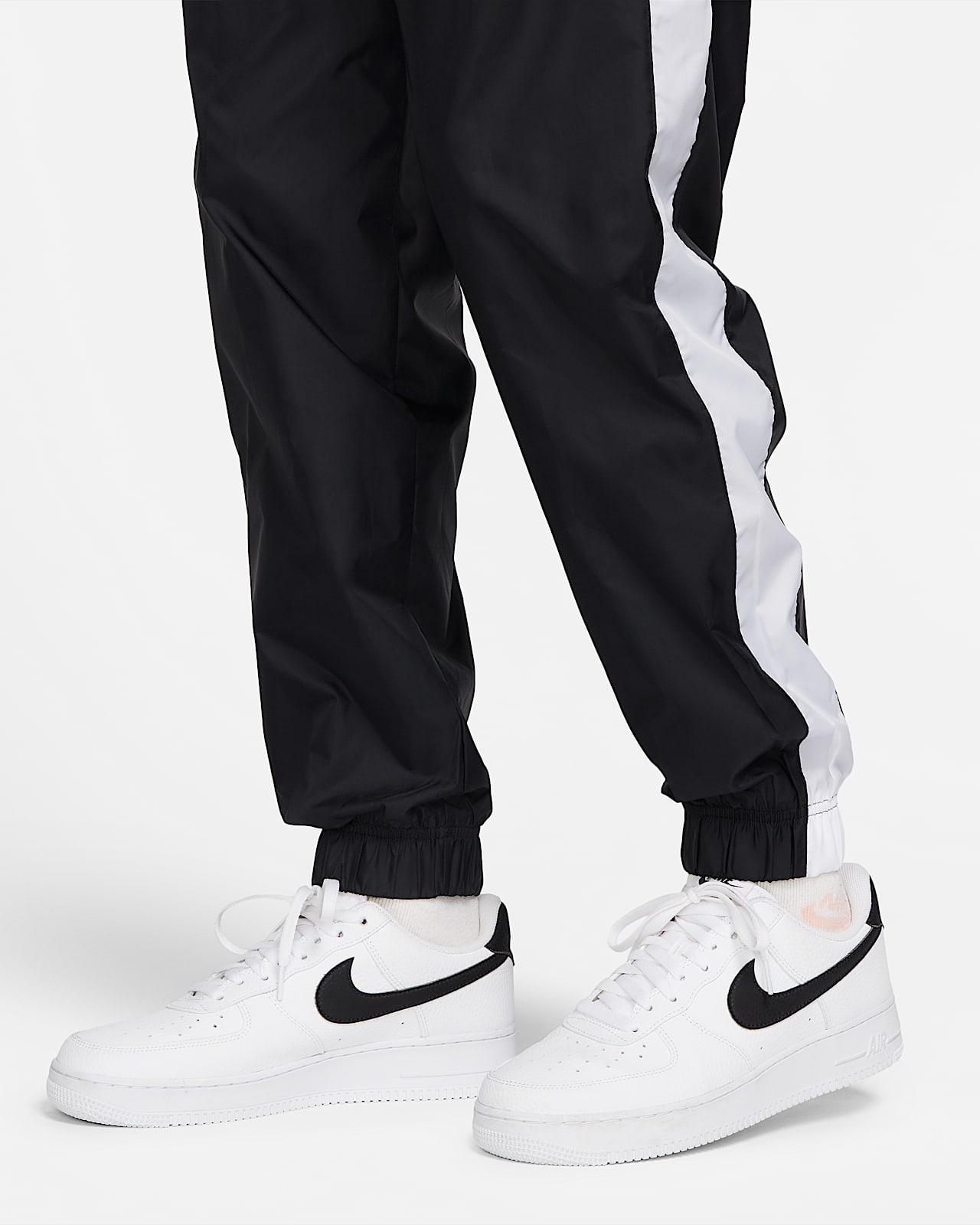 Nike Sportswear Geweven trainingspak met capuchon voor heren. Nike BE