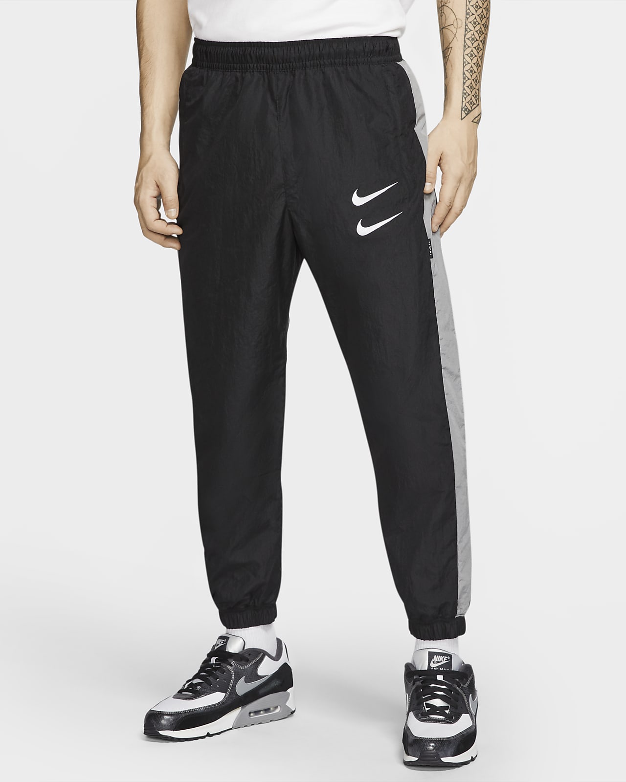 Polo galón Mercurio Nike Sportswear Swoosh Men's Woven Trousers. Nike ID