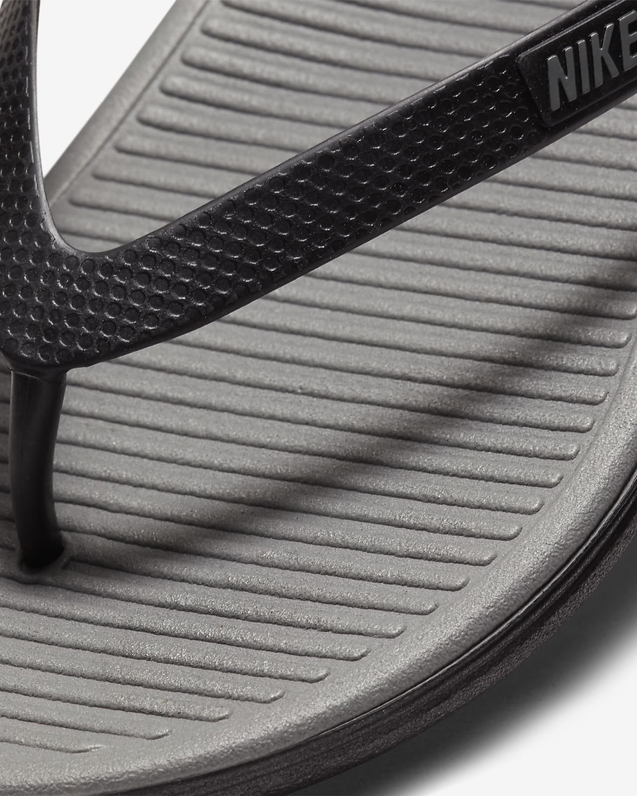 gray nike flip flops