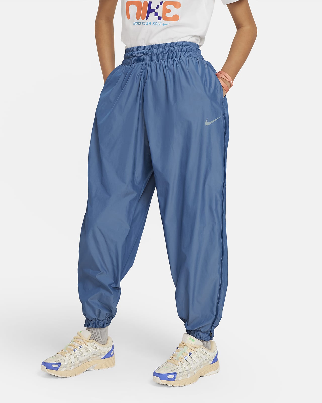 กางเกงขายาวผ้าทอเด็กโต Nike Sportswear (หญิง)