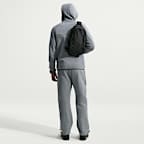 Pants de tejido Fleece con detalles de diseño reflejante con dobladillo abierto para hombre Nike Tech