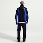Pantaloni in fleece a blocchi di colore con orlo aperto Nike Tech – Uomo