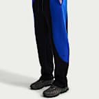 Pantaloni in fleece a blocchi di colore con orlo aperto Nike Tech – Uomo