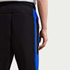Pantaloni in fleece a blocchi di colore con orlo aperto Nike Tech – Uomo