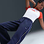 Dámské úpletové kalhoty Nike Sportswear Windrunner v zeštíhleném střihu se středně vysokým pasem