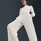 Pants de tejido Fleece cálidos de piernas anchas y tiro alto para mujer Nike Sportswear Phoenix Plush