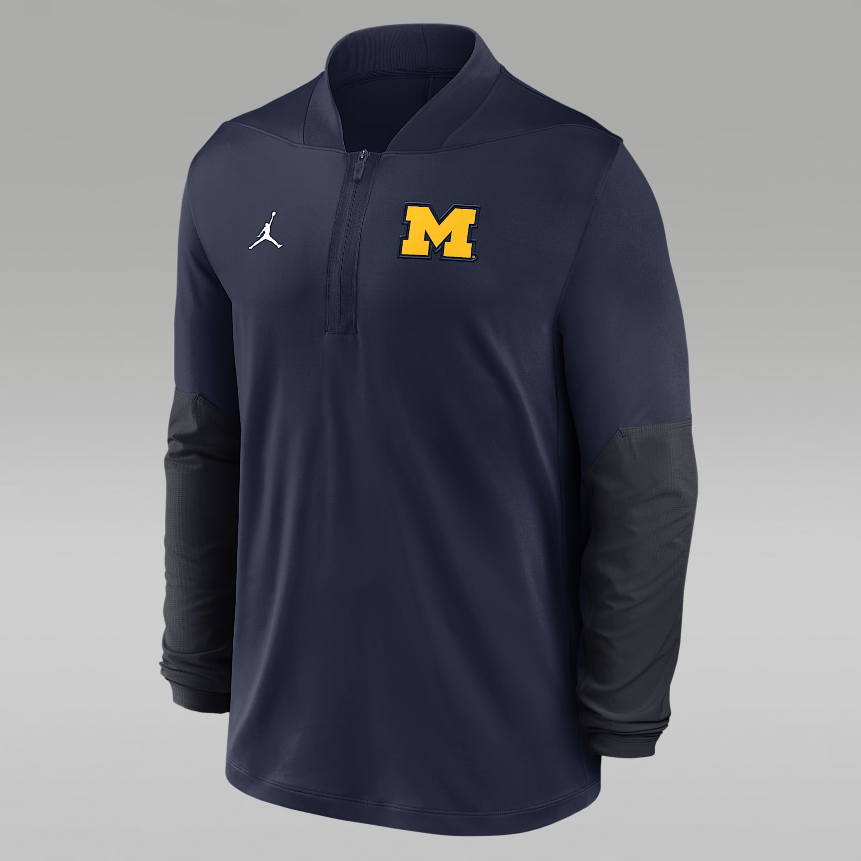 Playera universitaria marca Jordan Dri-FIT de medio cierre para hombre Michigan