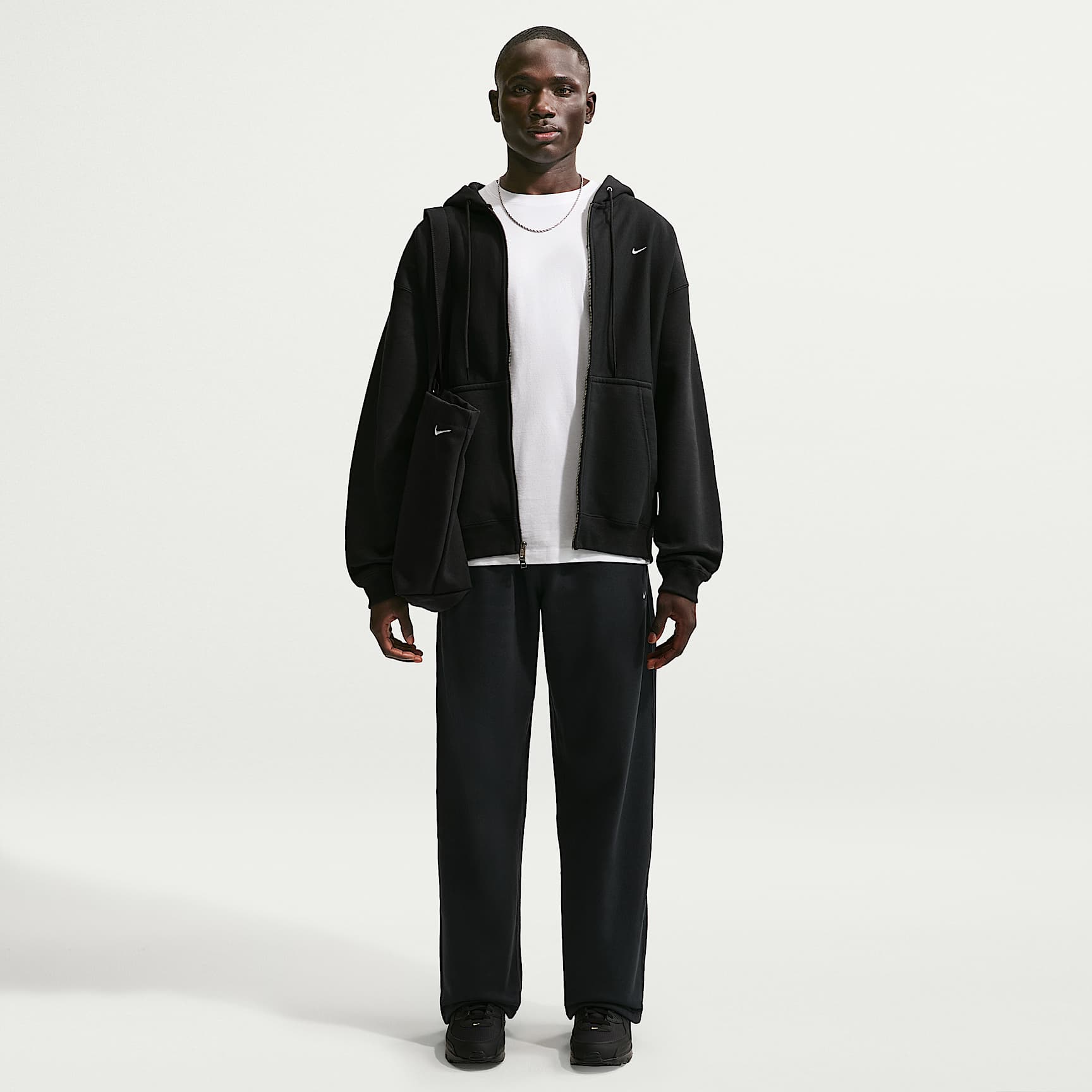 Pantaloni in fleece con orlo aperto Nike Solo Swoosh – Uomo