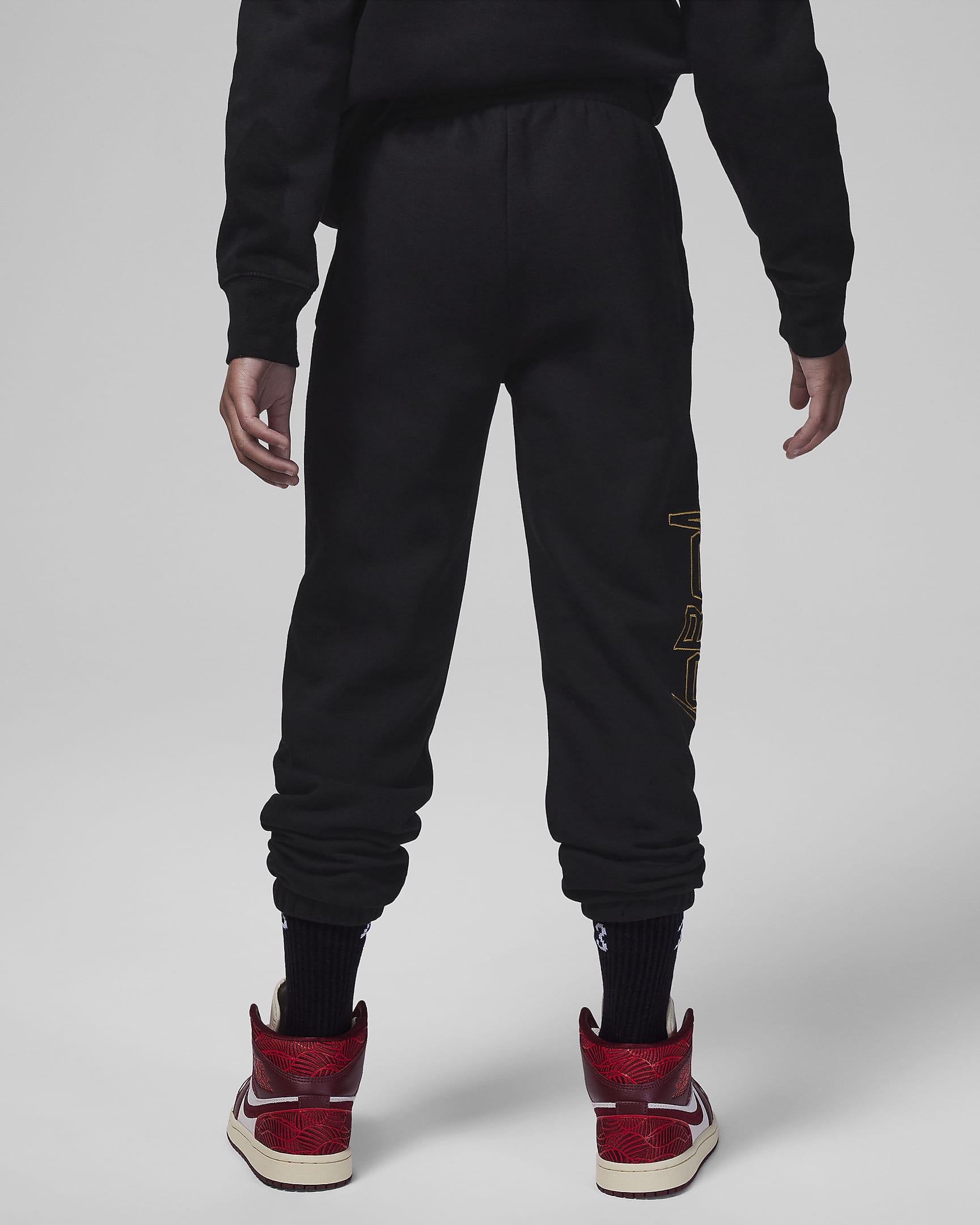 Jordan Take Flight Black and Gold Fleece Pants Big Kids Pants. Nike.com