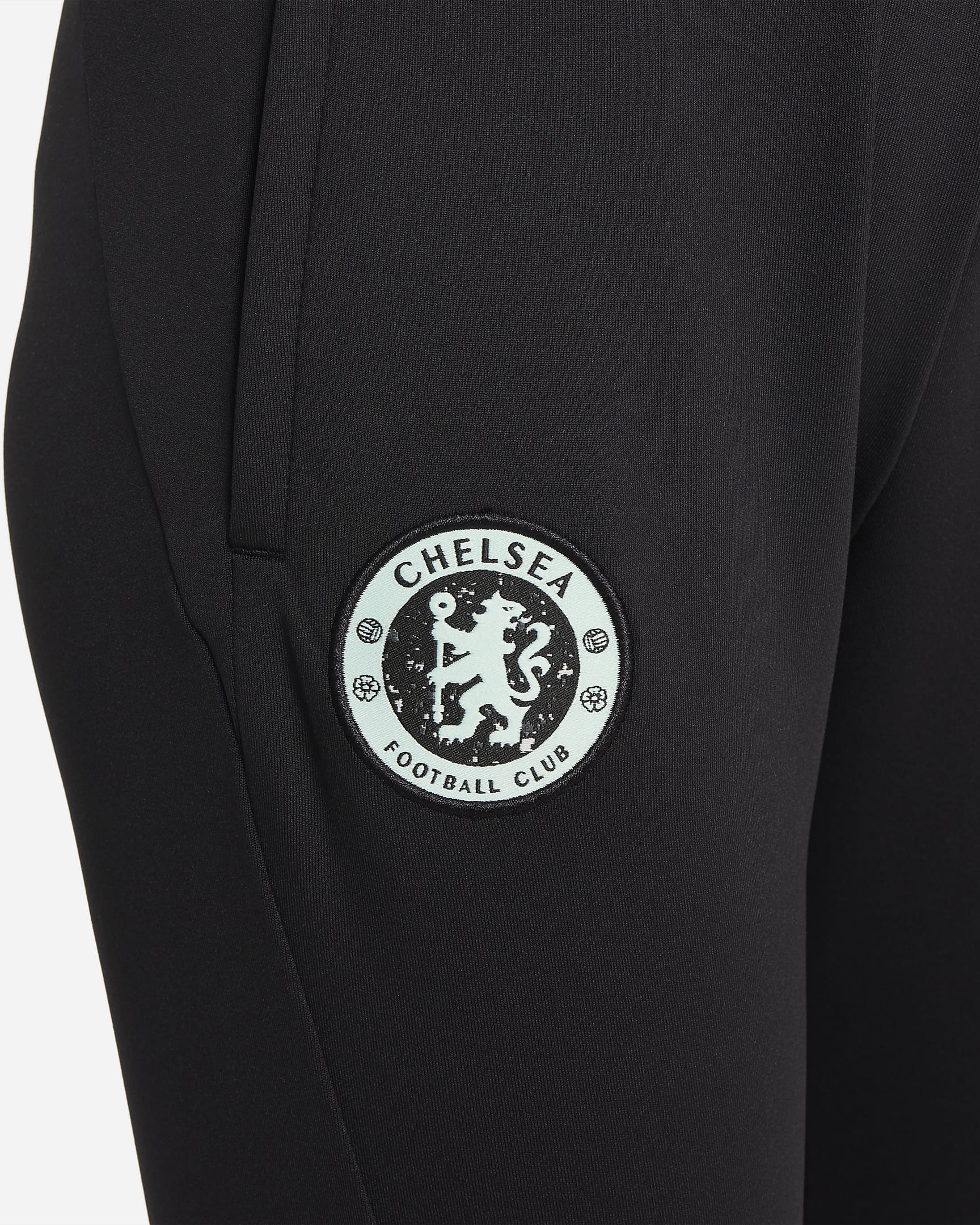 Dzianinowe spodnie piłkarskie dla dużych dzieci Nike Dri-FIT Chelsea F.C. Strike (wersja trzecia) - Czerń/Mint Foam