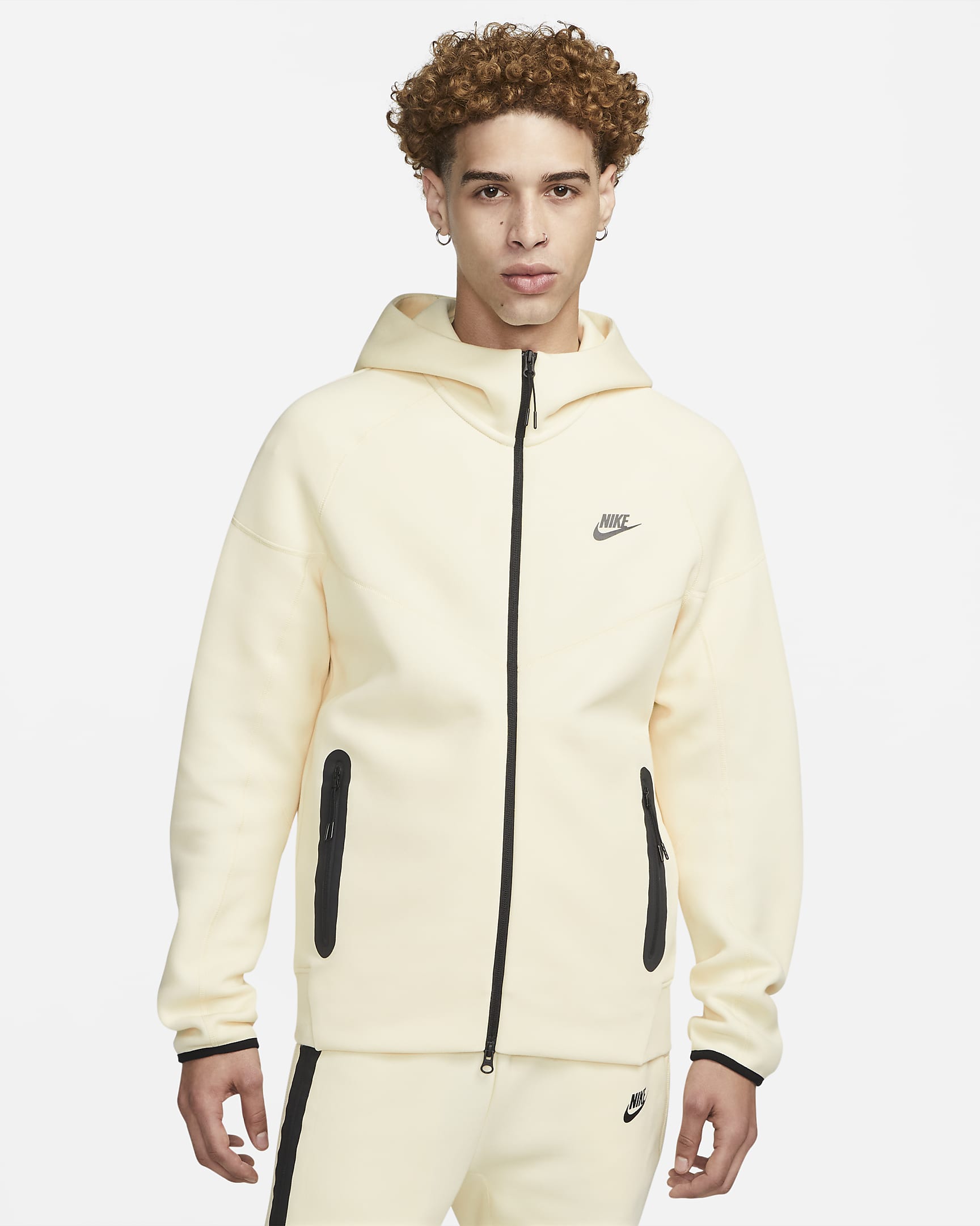 man wearing bright yellow-beige windrunner fleece jacket with Nike symbol