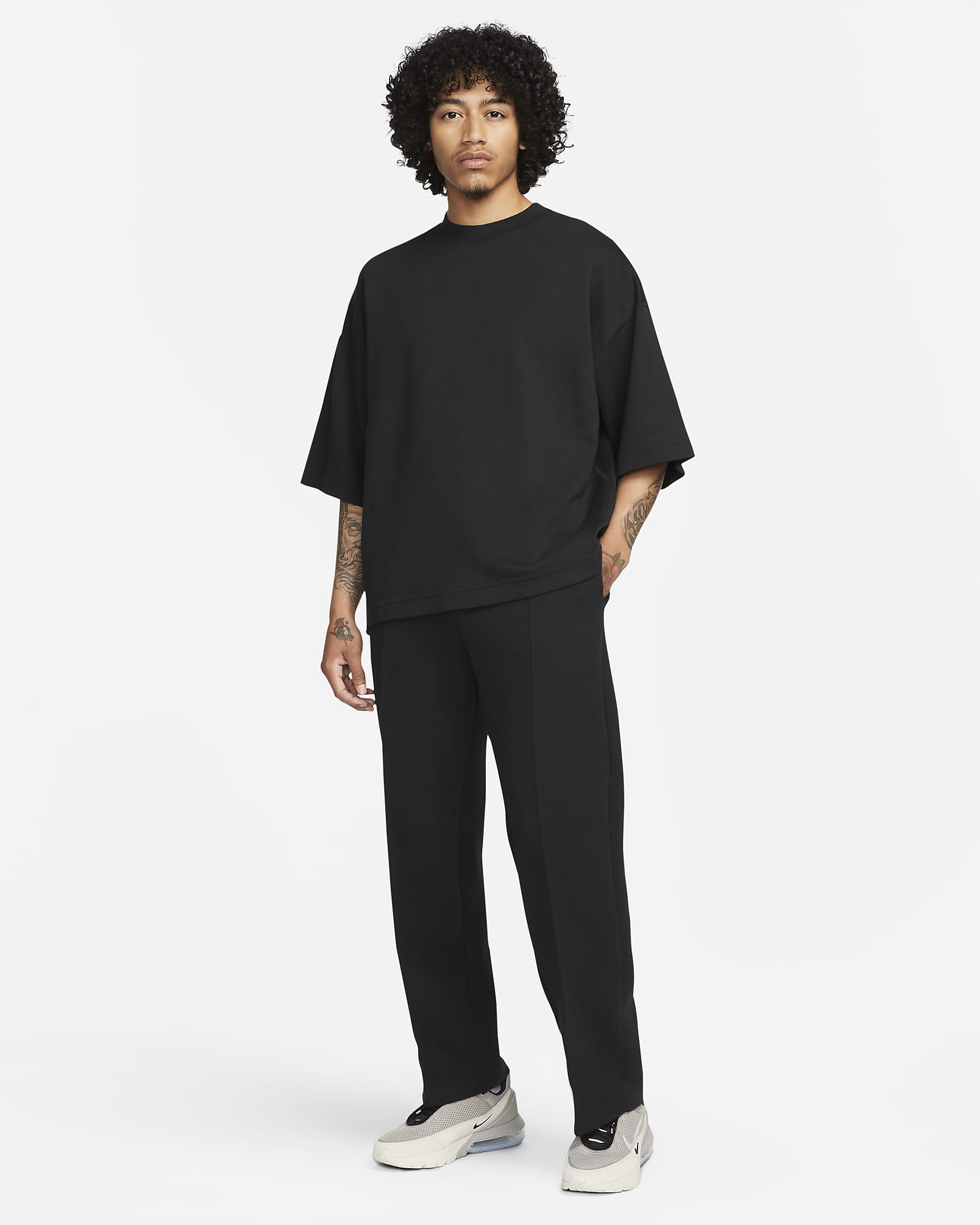 Pantaloni tuta Loose Fit con orlo aperto Nike Sportswear Tech Fleece Reimagined – Uomo - Nero/Nero