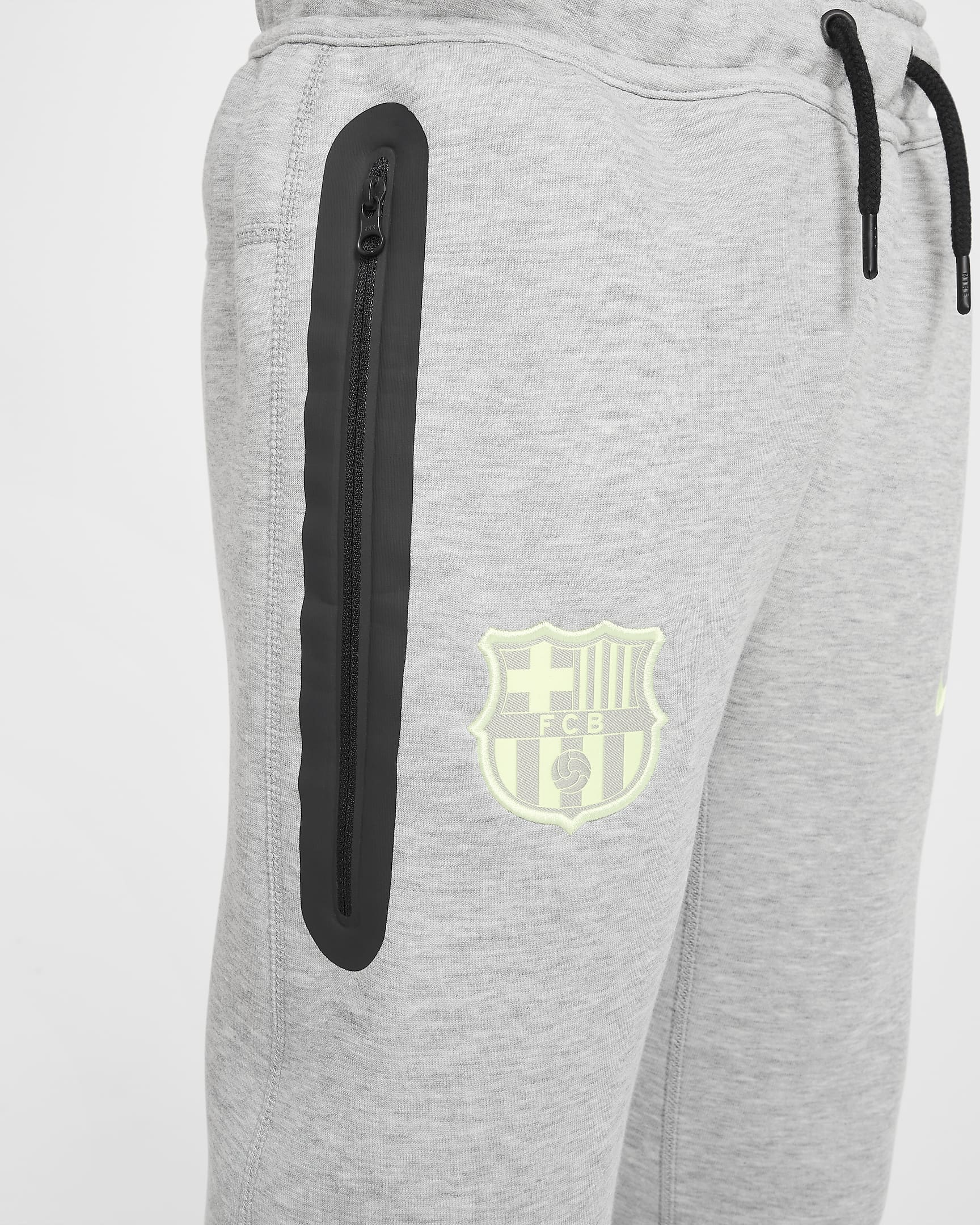 Spodnie piłkarskie dla dużych dzieci (chłopców) Nike FC Barcelona Tech Fleece - Dark Grey Heather/Barely Volt