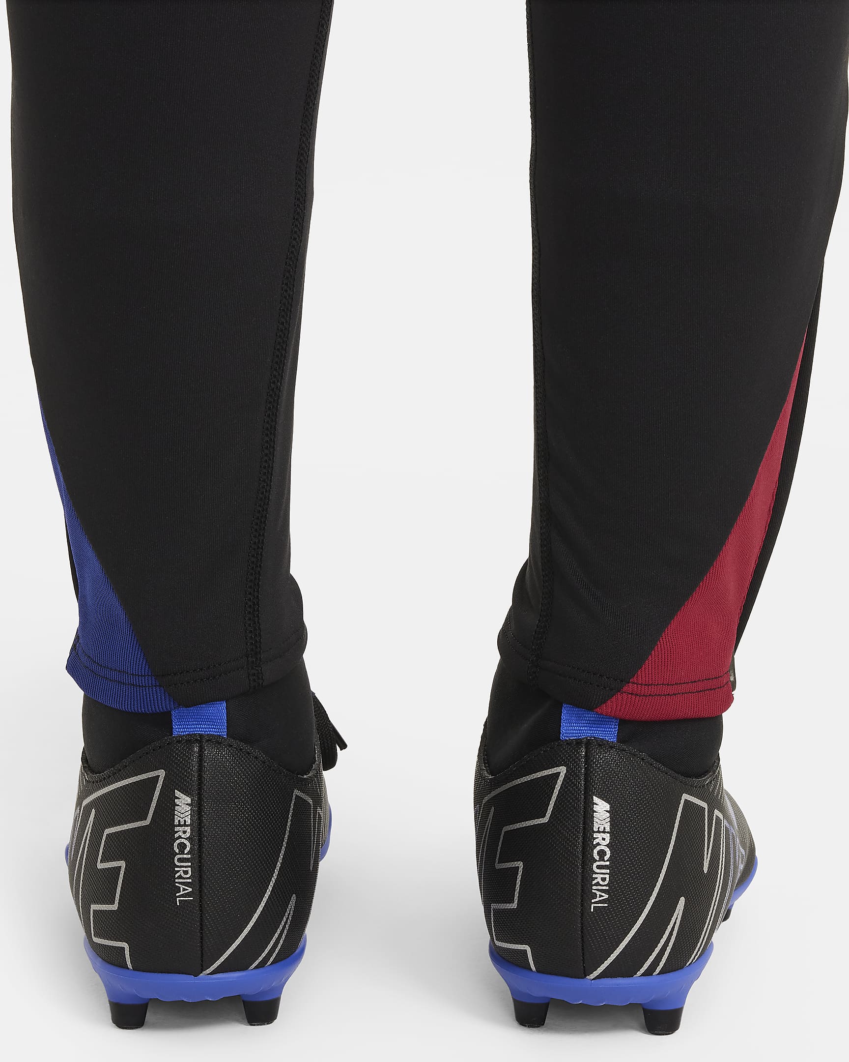 FC Barcelona Strike Pantalons de futbol de teixit Knit Nike Dri-FIT - Nen/a - Negre/Noble Red/Deep Royal Blue/Light Orewood Brown