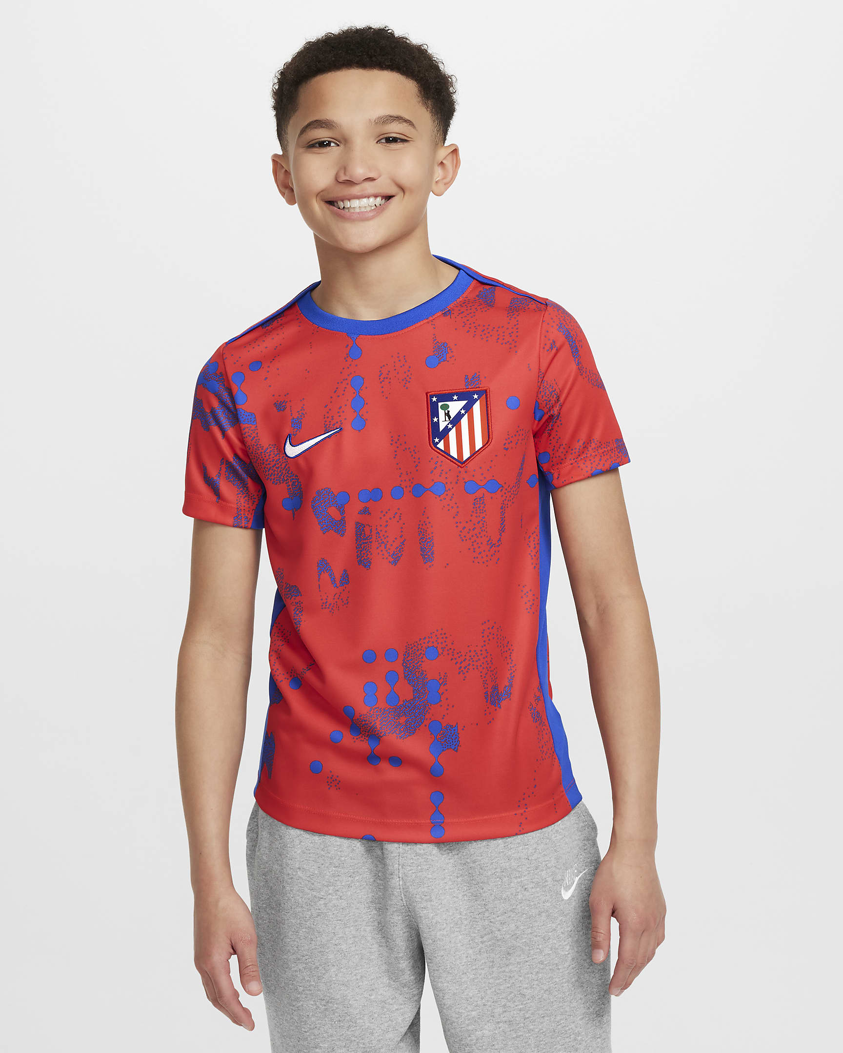 Atlético Madrid Academy Pro Older Kids' Nike Dri-FIT Football Short-Sleeve Pre-Match Top - Light Crimson/Hyper Royal/White