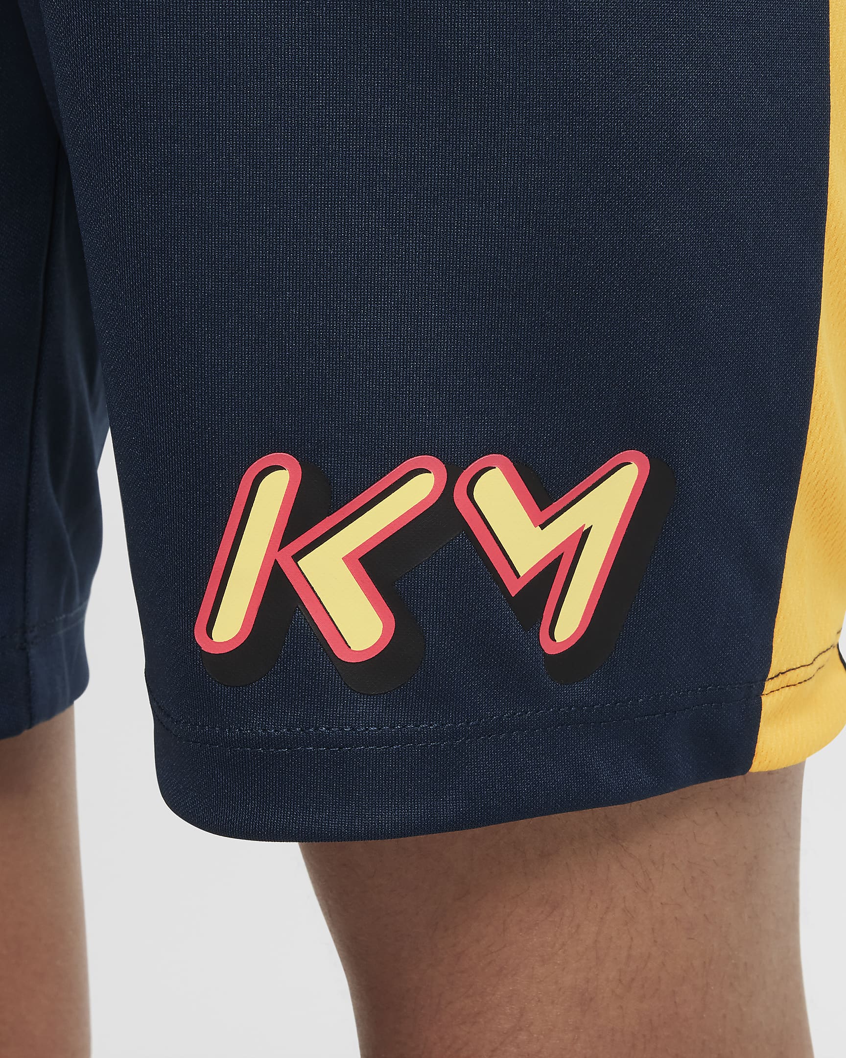 Kylian Mbappé Academy23 voetbalshorts met Dri-FIT voor kids - Armory Navy/Laser Orange