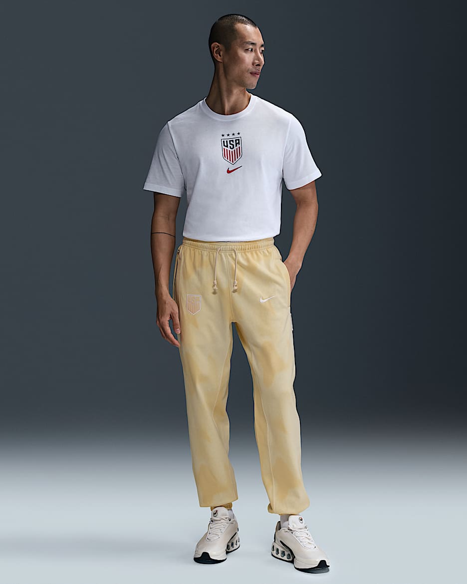 Pants de fútbol Nike Dri-FIT para hombre de la selección nacional de fútbol masculino de Estados Unidos Standard Issue - Leche de coco/Blanco