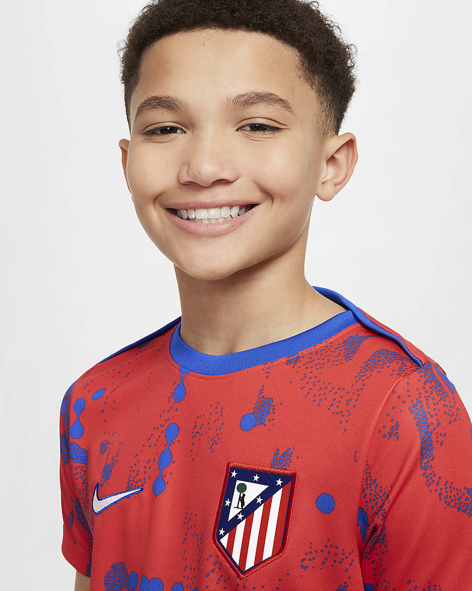 Atlético Madrid Academy Pro Older Kids' Nike Dri-FIT Football Short-Sleeve Pre-Match Top - Light Crimson/Hyper Royal/White