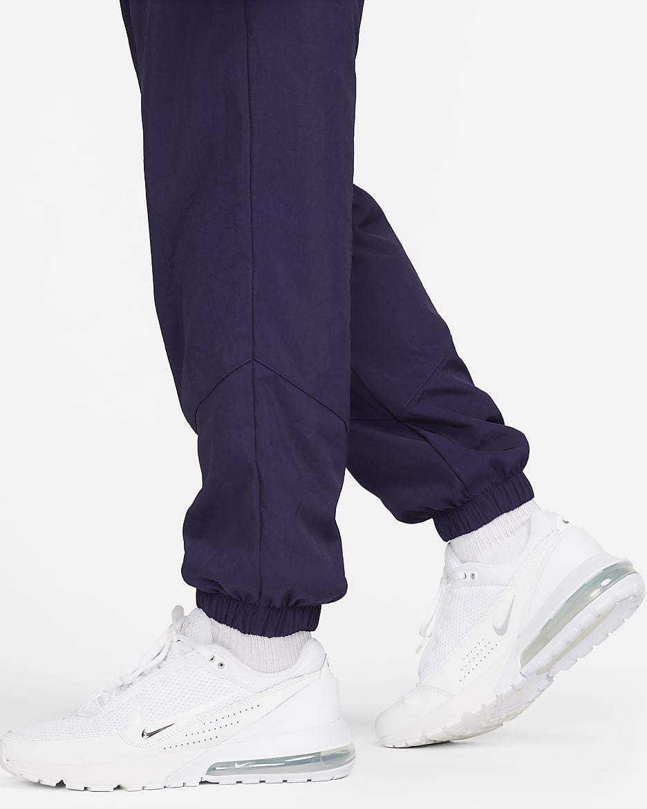 Pantalon d‘hiver tissé Nike Windrunner pour homme - Purple Ink/Blanc